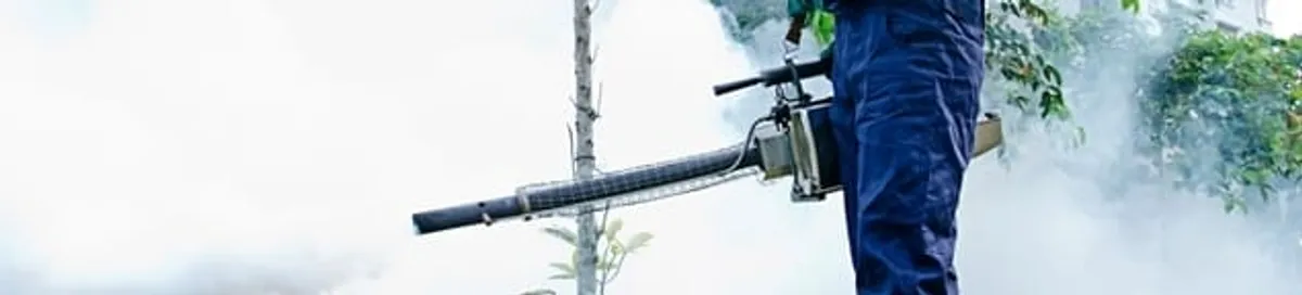Pest control technician fogging an outdoor area for insect control in Aurora, CO